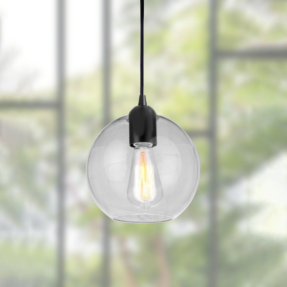 Closeup of clear glass globe shade of Matte Black Clear Glass Globe Instant Pendant by Worth Home