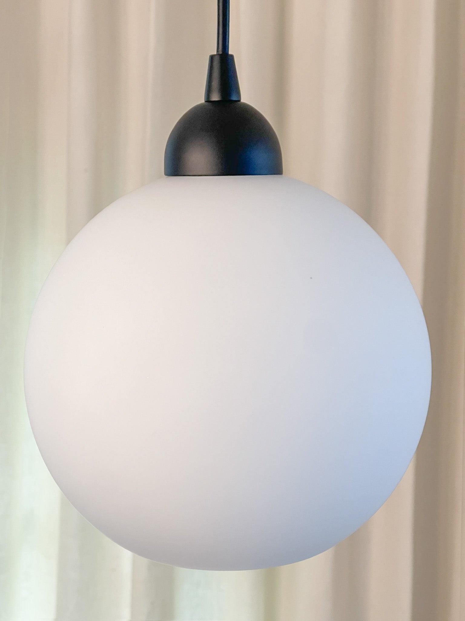 Closeup of Matte Black Milk Globe Instant Pendant Shade